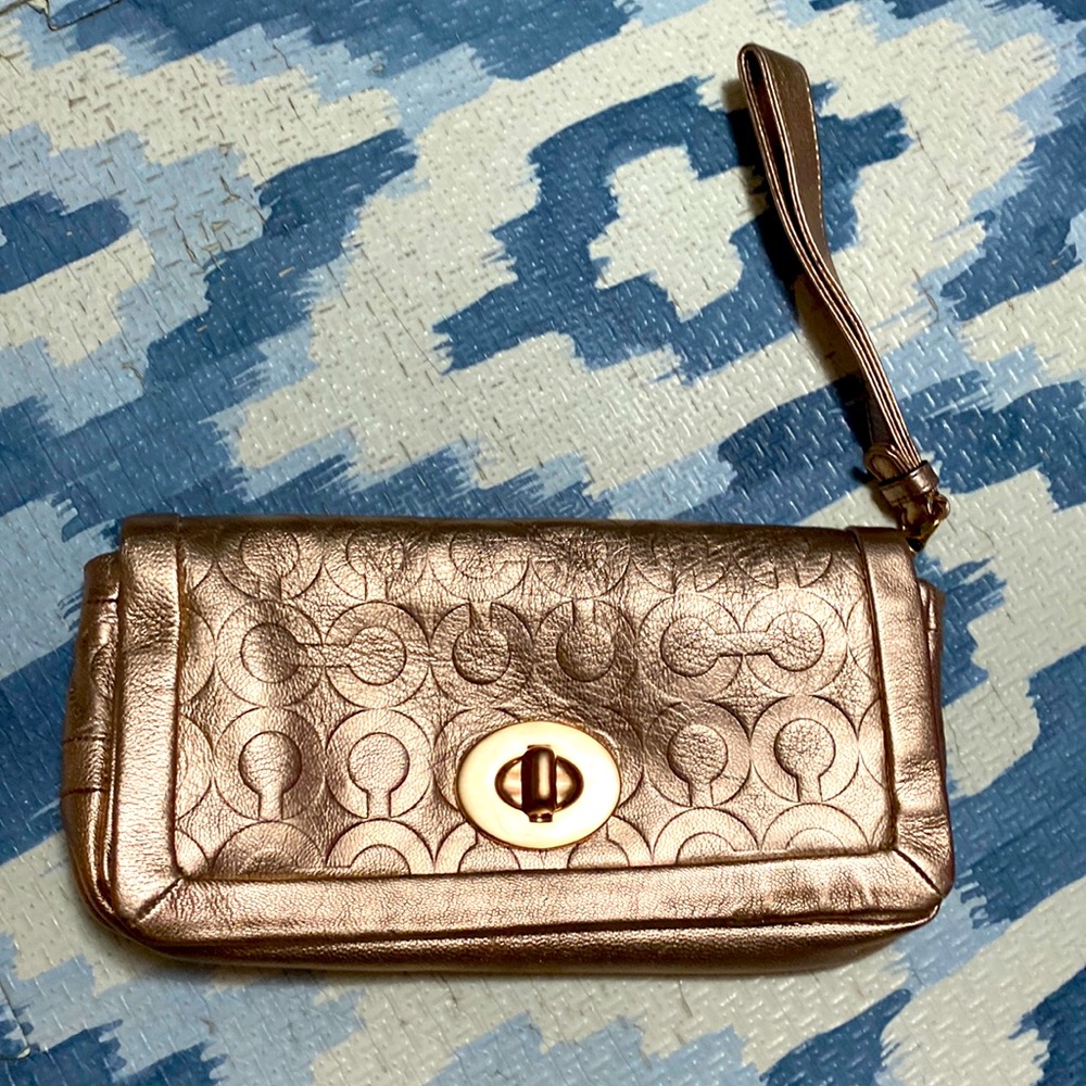 Coach clutch in rose gold logo leather